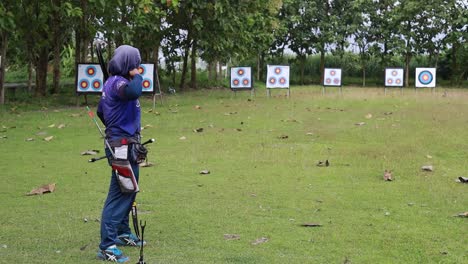 Indonesia---April,-2023-:-Asian-young-woman-exercising-and-concentration-with-outdoor-archery