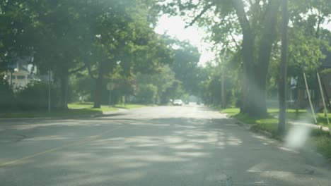POV-From-Window-Going-Street-Past-On-Coming-Traffic-In-Neighborhood-In-Michigan