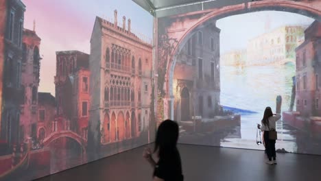Visitors-take-photos-as-they-are-seen-at-the-animated-and-immersive-360-degrees-projections-exhibition-entitled-'En-Voyage-with-Claude-Monet'-showcasing-French-impressionist-Claude-Monet's-paintings