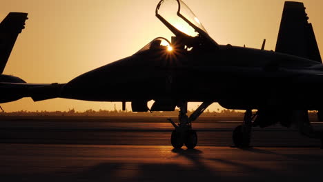 Silhouette-a-Blue-Angel-on-the-tarmac-as-the-jets-are-prepped-for-an-airshow-routine-early-morning-golden-sunrise-in-Key-West