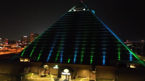 Memphis-Pyramid,-the-Bass-Pro-Shop-in-Memphis-Tennessee-at-night-with-drone-video-moving-up-from-the-ground