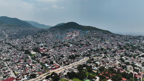 Aerial-view-overlooking-a-metropolitan-slum-area-with-a-face-painted-on-buildings,-in-Ecatepec-de-Morelos,-Mexico