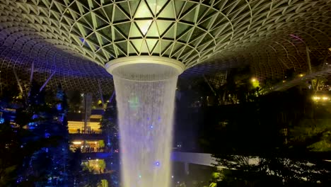 Slow-motion-and-tele:-Tropical-indoor-vegetation-sorrounding-tallest-indoor-waterfall-at-Singapore-airport