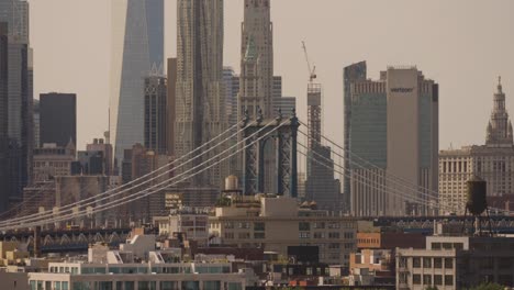 Wide-shot-of-Manhattan-bridge,-One-world-trade-center-and-Verizon-Building-In-NYC-at-dusk
