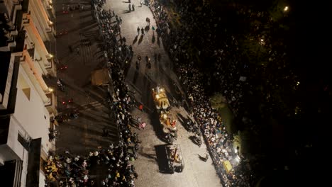 People-Carrying-Parade-Floats-In-The-Street-During-Procession-Of-The-Holy-Week-In-Antigua,-Guatemala---aerial-drone-shot