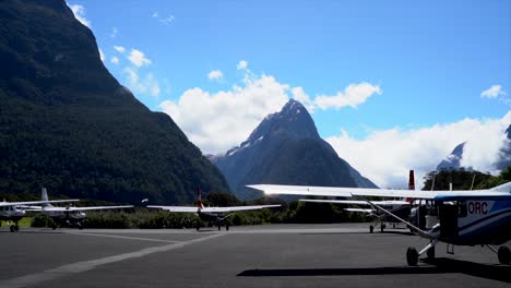 Milford-Sound-Airport-with-small-planes-and-Mitre-Peak-in-the-background