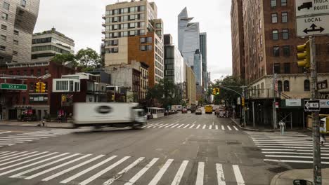 timelapse-and-motionlapse-from-the-intersection-W-23-St-and-10-Av,-New-York,-NY-streets-with-people-and-vehicles-moving-with-the-skyscrapers-and-edge-building-in-the-background