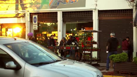 People-walking-in-street-in-front-of-Flower-shop-in-Barrio-Italia,-Santiago