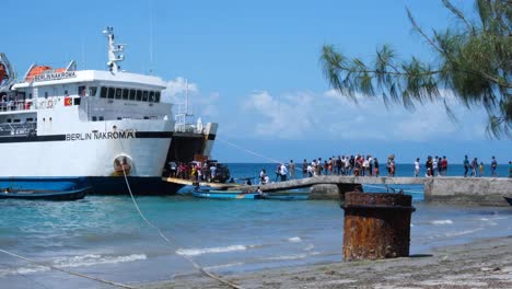 People-walking-off-the-passenger-ferry-arriving-on-market-day-on-tropical-Atauro-Island-from-Capital-Dili-in-Timor-Leste,-Southeast-Asia
