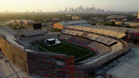 Aerial-view-around-the-TDECU-stadium,-at-the-University-of-Houston,-golden-hour-in-Texas,-USA