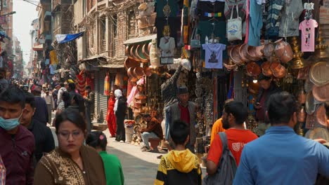 Cityscape-view-of-a-crowded-narrow-street-full-of-various-shops-and-markets,-in-Kathmandu,-Nepal