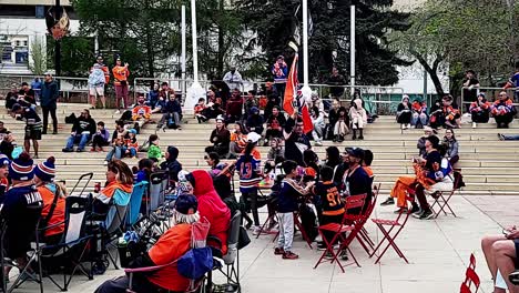 Winston-Churchill-Square-Oilers-fans-excited-cheering-guy-running-with-giant-team-flag-on-hockey-stick-around-and-through-seating-area-in-front-of-camera-during-5-to-0-lead-Edmonton-vs-Las-Vegas-E2-2
