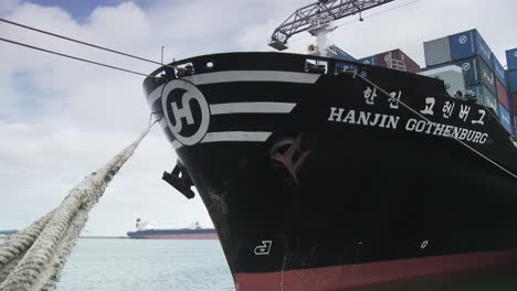 Hanjin-Gothenburg,-black-cargo-vessel-fastend-with-dew-in-dockyard,-cloudy-day