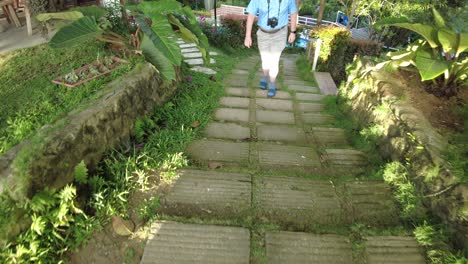 An-American-citizen-walking-upstairs-the-garden-of-Jomax-Peak-in-Don-Salvador-Benedicto,-Negros-Occidental,-Philippines