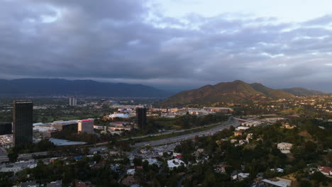 Drone-shot-flying-toward-the-Universal-City,-moody-sunset-in-Los-Angeles,-USA