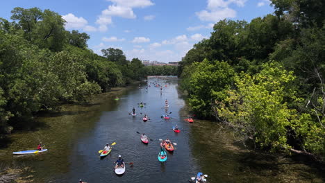 Groups-of-Kayakers-and-Paddle-Boarders-travel-down-Lady-Bird-Lake-in-Austin-Texas