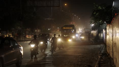 Busy-Traffic-at-Night-in-New-Delhi-India,-Bus-passing-by