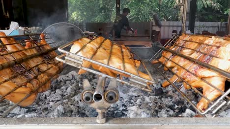 View-Of-Grilled-Chicken-Being-Cooked-Over-Outdoor-Charcoal-Grill-Turning-In-Grid-Grill-In-Krabi