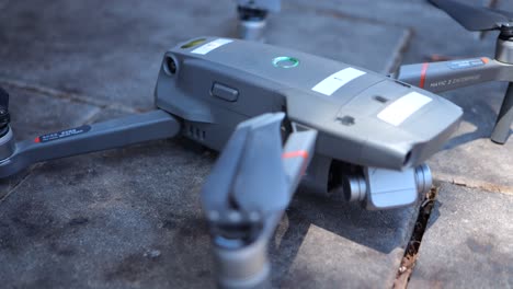 Drone-pilot-adding-battery-to-the-drone-and-turning-it-on,-close-up