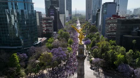 Aerial-view-away-from-the-Angel-of-Independence-statue,-during-the-International-Women's-Day-parade-,-in-Mexico-city