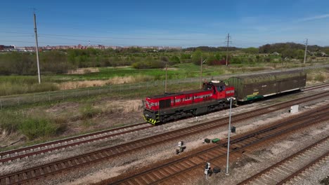Aerial-view-The-locomotive-with-the-attached-wagon-is-standing-on-the-track