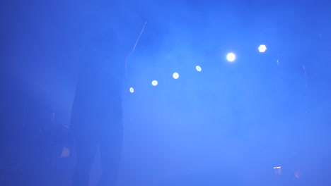 Description-of-a-Dancer-Performing-in-Smoke-under-Stage-Lights