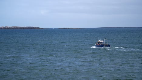 A-small-passenger-ferry-transports-tourists-and-locals-from-Seahouses-Harbour-to-the-Farne-Islands,-in-the-North-Sea-off-the-coast-of-Northumberland