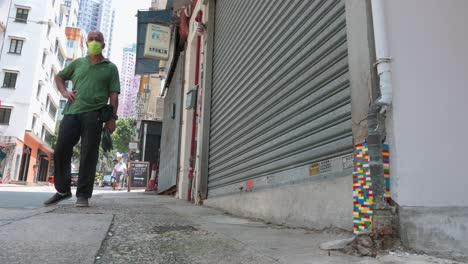 A-man-stands-in-front-of-a-building-entrance-is-seen-decorated-with-colorful-Lego-bricks