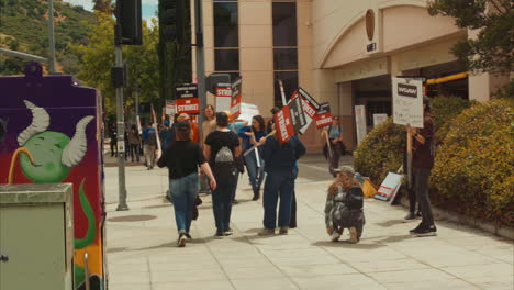 Street-view-of-Writers-Guild-of-America-on-strike-at-Warner-Brothers-Studios-surrounded-at-Gate-3-on-Olive-Avenue-in-Burbank,-California