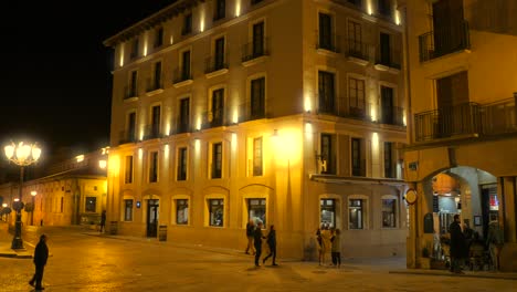 Main-Square-Of-Historic-Spanish-Town-Of-Alcañiz-With-Tourists-At-Night---wide