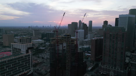 Drone-shot-over-the-Skanska-1550-on-the-green-Construction-site,-dawn-in-Houston,-USA