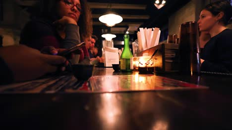 Chicago,-IL-USA-April-2nd-2023:-Hyper-lapse-of-a-black-couple-eating-dinner-in-a-dark-Japanese's-ramen-bar