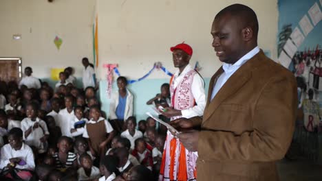 School-principal-in-brown-suit-addresses-students-in-Kalabo-Zambia