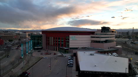 Twilight-aerial-view-of-Ball-Arena-in-Denver-Colorado,-arcing-shot