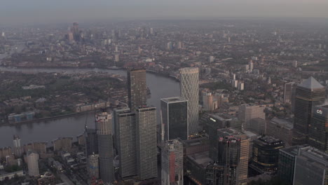Slow-high-aerial-shot-over-Canary-wharf-revealing-central-London-skyline-blue-hour
