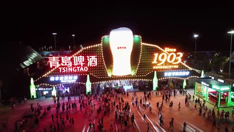 Tsingtao-beer-tent,-a-crowded-place-with-many-guests-enjoying-the-Qingdao-beer-festival-at-night,-Oktoberfest-in-Shandong-Province,-China
