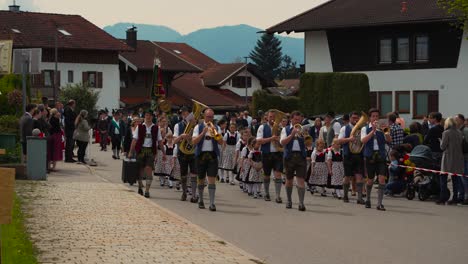 Music-brass-group-band-in-traditional-Bavarian-clothes,-Lederhose-and-Dirndl-at-Maibaumaufstellen