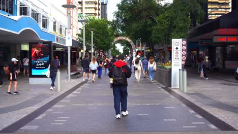 Point-of-view,-walk-through-shot-capturing-busy-Queen-Street-Mall,-popular-pedestrian-shopping-precinct-in-downtown-Brisbane-city,-central-business-district,-Queensland,-Australia