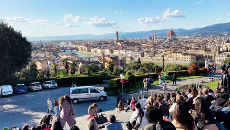 Crowd-of-tourists-sitting-in-Piazzale-Michelangelo-enjoying-the-view-of-Florence
