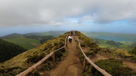 Sao-Miguel,-Portugal,-March-30,-2023:-Tourists-walking-through-Hell's-Window-Path-in-Sao-Miguel,-Azores