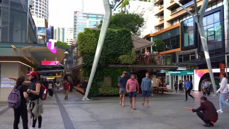 Panning-view-capturing-bustling-Queen-Street-Mall,-popular-pedestrian-shopping-precinct-in-downtown-Brisbane-city,-central-business-district,-Queensland,-Australia