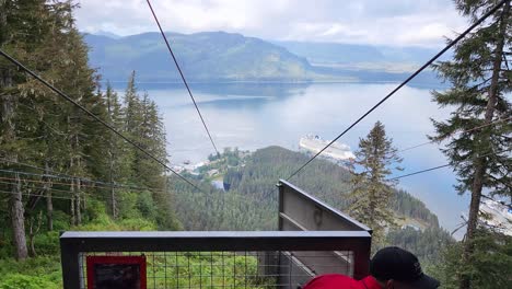 ZipRider-zip-line-ride-at-Icy-Strait-Point-in-Hoonah-Alaska-release-viewed-from-back-of-platform-on-clear-day-with-cruise-ships-in-background