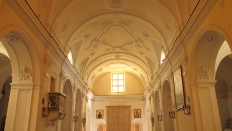 Inside-Santa-Sofia-Church-With-Benches-In-Anacapri,-Capri,-Italy---tilt-up