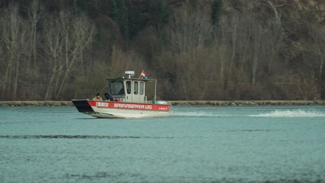 A-fast-aluminum-fire-boat-is-driving-upstream-on-the-Danube,-a-river-running-through-Austria,-towards-their-next-assignment
