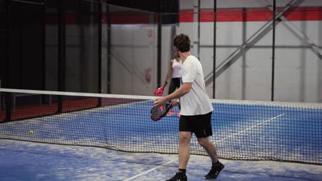 Murcia,-Spain,-May-23,-2023:-Young-sportswoman-and-man-couple-playing-padel-tennis-in-slow-motion