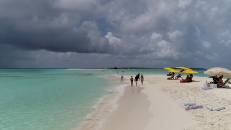 PEOPLE-chilling-and-walking-tours-ON-pristine-WHITE-SAND-BEACH,-DRONE-SHOT-CAYO-DE-aGUA-ISLAND