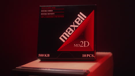 Brand-new-pack-of-Maxell-floppy-disks-on-top-of-a-floppy-drive