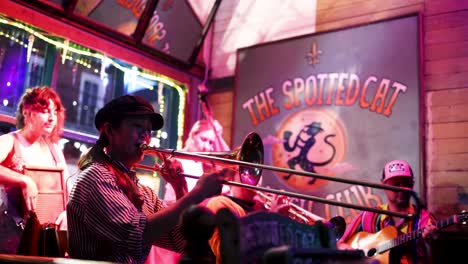 young-woman-is-passionately-playing-a-trombone-at-a-New-Orleans-night-club-for-tourist-at-night