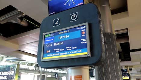 Baggage-claim-information-screen-at-airport-terminal-in-Porto,-Portugal