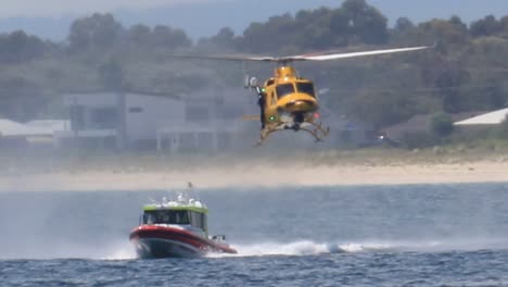 RAC-Rescue-Helicopter-Following-Marine-Rescue-Boat-With-Crew-Ready-To-Board